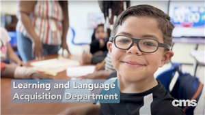 open house video frame of boy smiling during classroom instruction (links to open house videos)